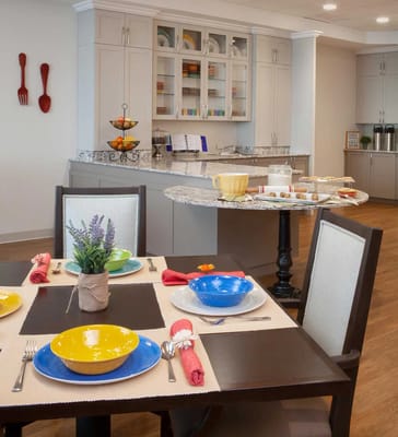 Dining area set up for a meal with colorful tableware