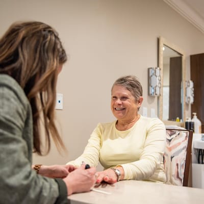 A resident enjoying a manicure in a salon