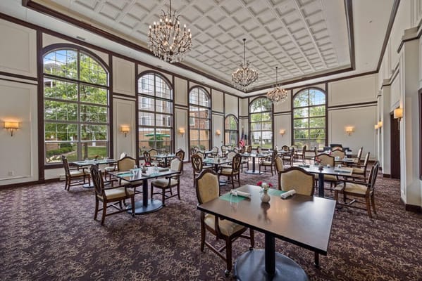 Elegant dining room with chandeliers and large windows