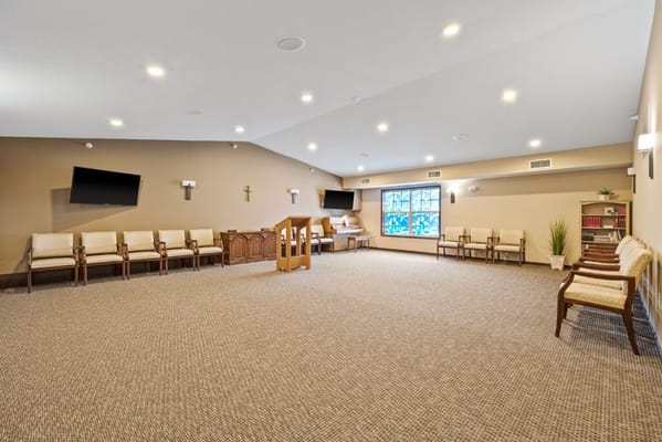 A spacious, empty chapel with seating and a podium