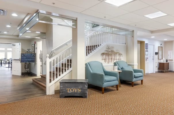 Bright common area with seating and stairs