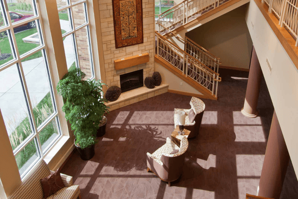 Bright lobby area with seating and fireplace