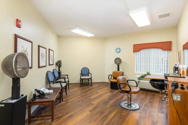 Interior view of a salon space with chairs and lighting