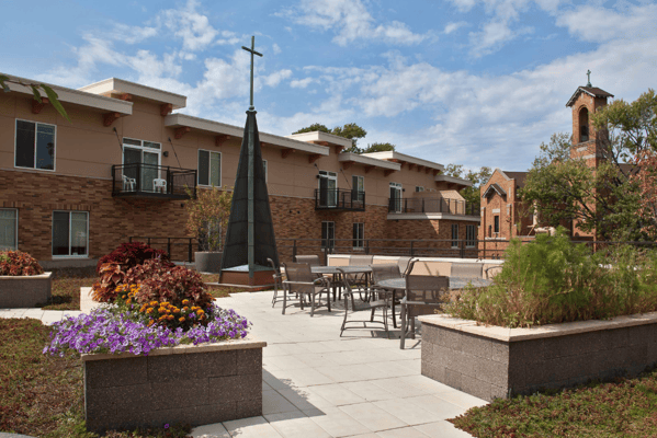 Outdoor space with seating and landscaping in a senior living facility