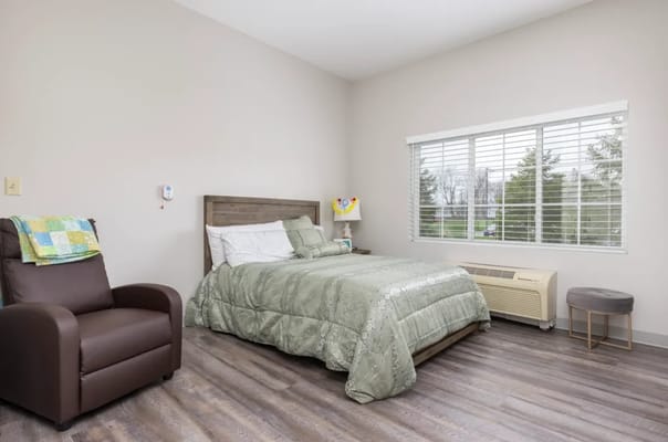 Private resident room with a bed and seating area