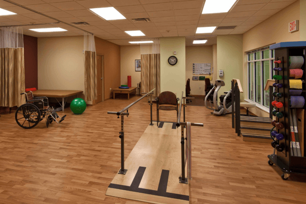 Rehabilitation gym with exercise equipment and therapy bars