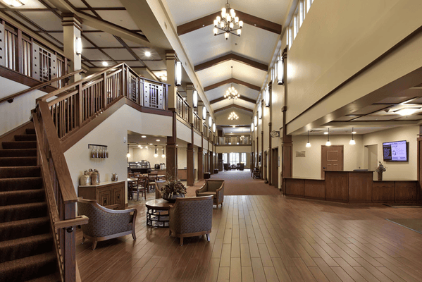 Bright, spacious lobby area with seating and staircase