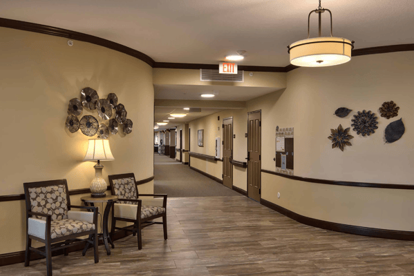 Interior hallway of a senior living facility with seating area