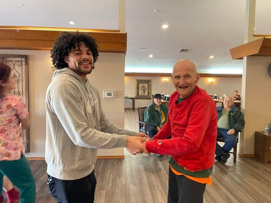 Residents enjoying a dance activity in a common area
