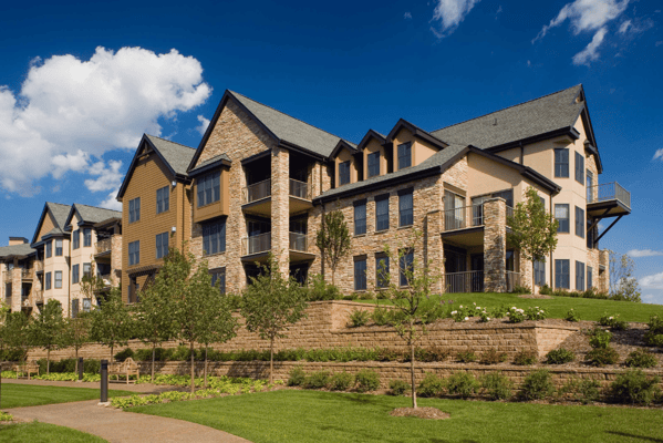 Exterior view of a senior living facility with landscaping