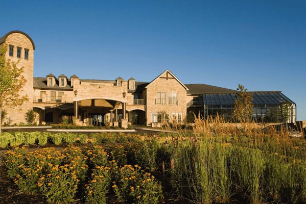 Exterior view of Highland Path with gardens and flowers