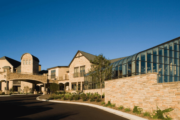 Exterior view of Highland Path with stone walls and greenery