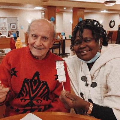 Residents enjoying dessert together in a dining area
