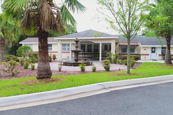 Exterior view of Her Heart Gardens Assisted Living with landscaping