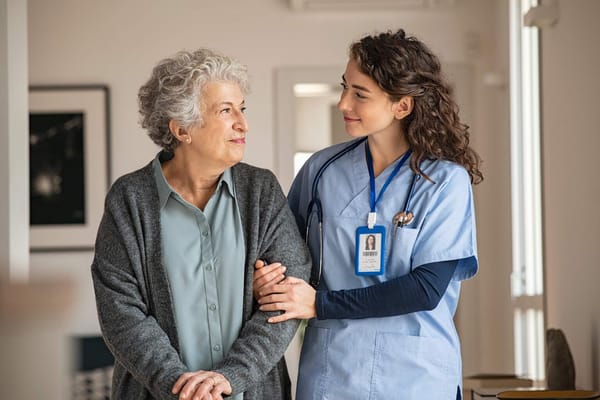 A caregiver assisting a senior resident