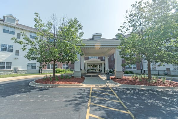 Front entrance of Heritage Woods of Batavia surrounded by trees