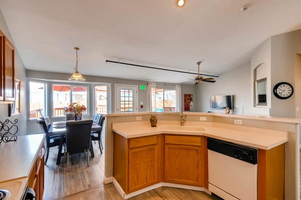 Bright kitchen area with dining space and windows.