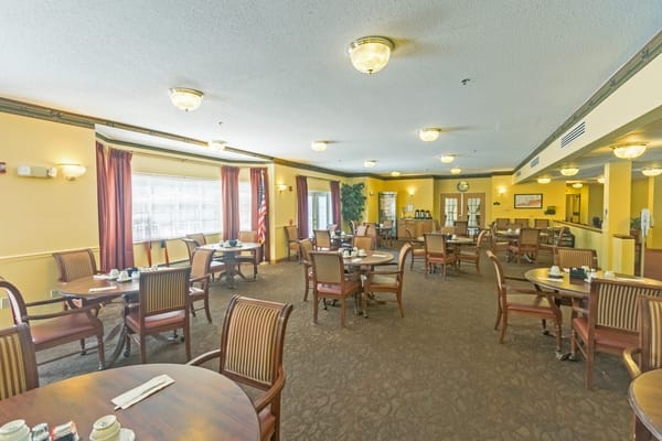 Dining room with tables and chairs set for meals