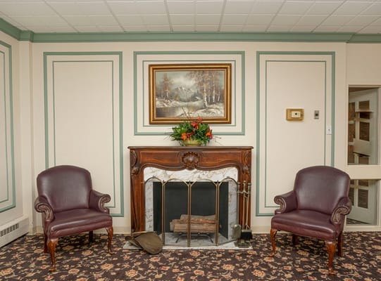 Cozy common area with fireplace and chairs
