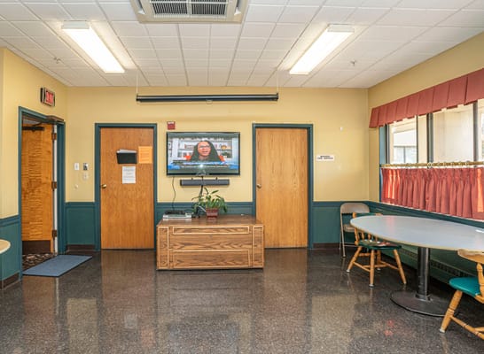 Common area with seating and a TV in the facility