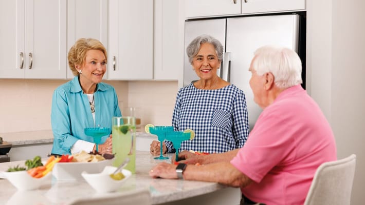 Residents enjoying time together in a bright kitchen