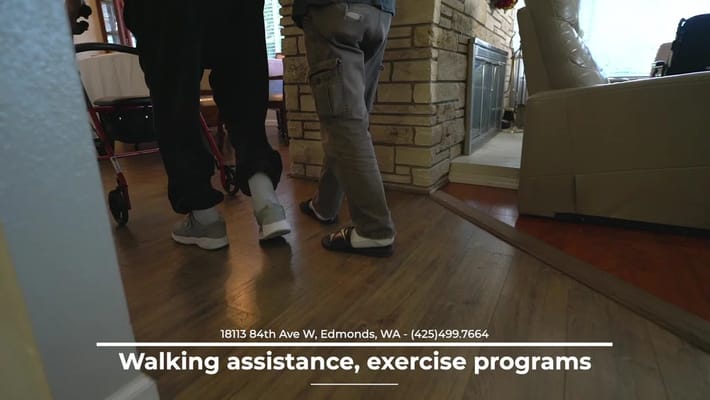 Residents walking with assistance in a home interior