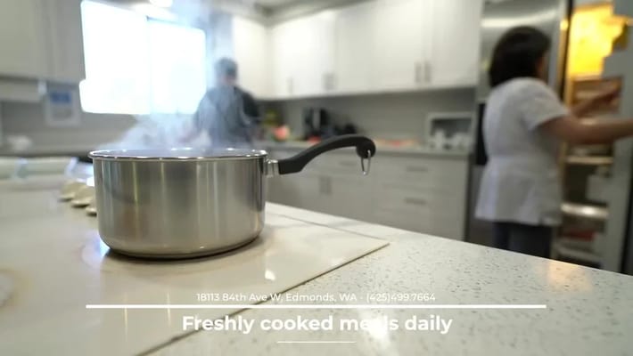 Cooking in the facility kitchen with staff present