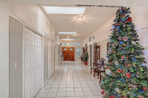 A decorated hallway with a Christmas tree