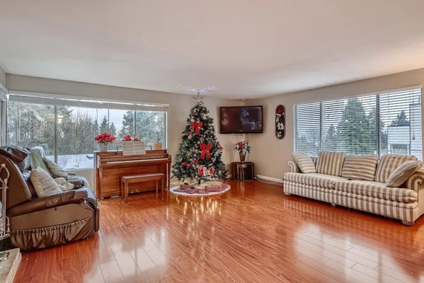 Bright living room with a Christmas tree and piano
