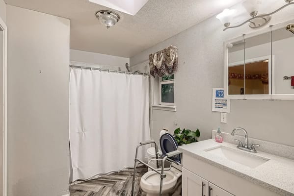 Clean bathroom facility with shower and sink.