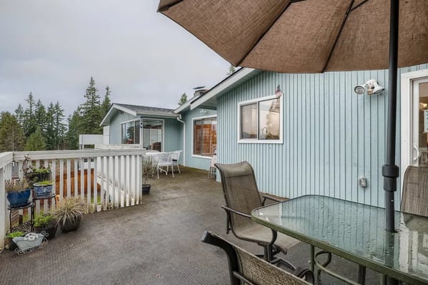 Outdoor seating area with umbrellas and greenery