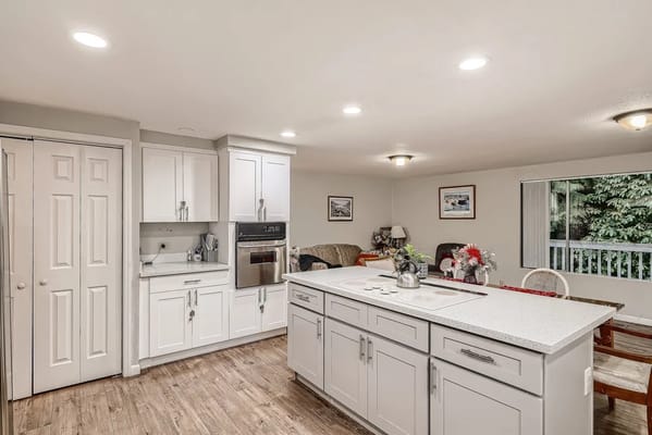 Brightly lit kitchen area with cozy seating