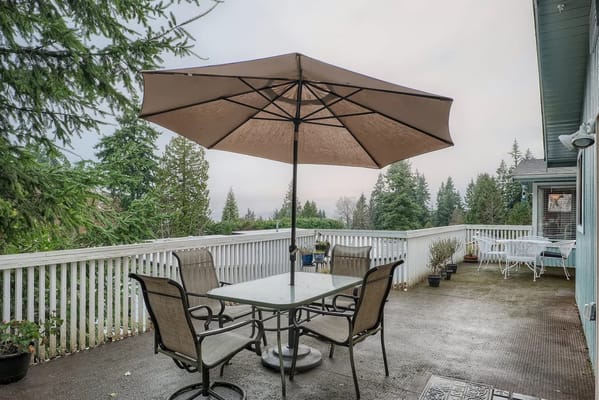 Outdoor patio area with seating and an umbrella