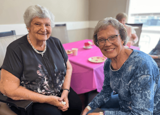 Two residents smiling during a social event