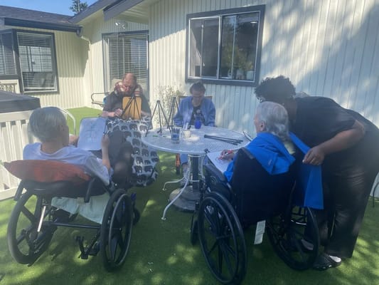 Residents engaging in a crafting activity outdoors