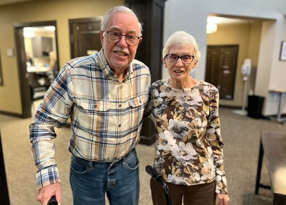 Two residents smiling together in a common area