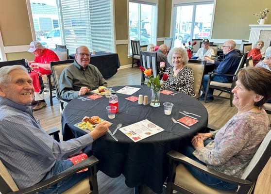 Residents enjoying a meal together at a dining table