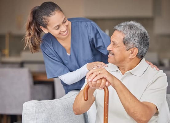 A caregiver interacting with a senior resident in a common area