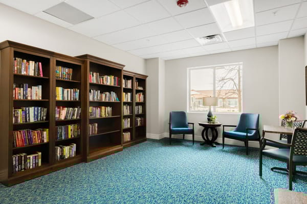 Interior of a cozy library with bookshelves and seating