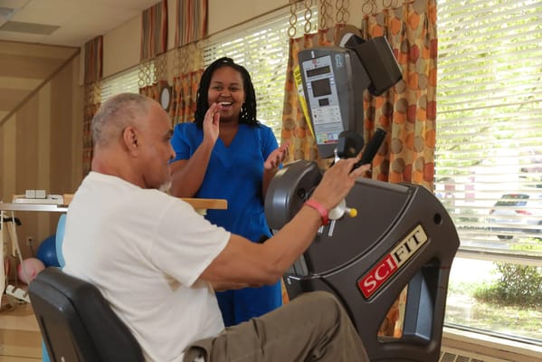 Residents participating in a physical activity session with staff assistance