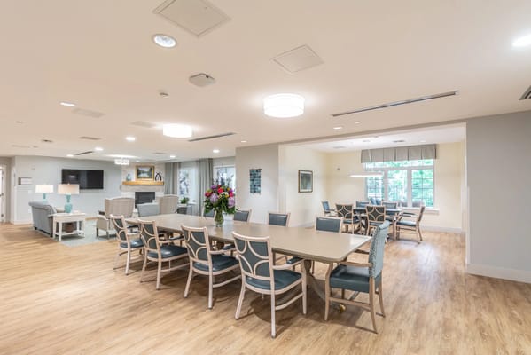 Bright common area with seating and dining tables