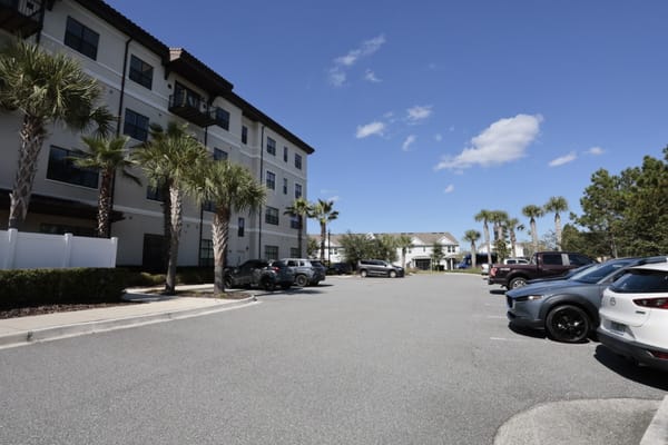 Outdoor parking lot at Grand Living At Tamaya with palm trees.