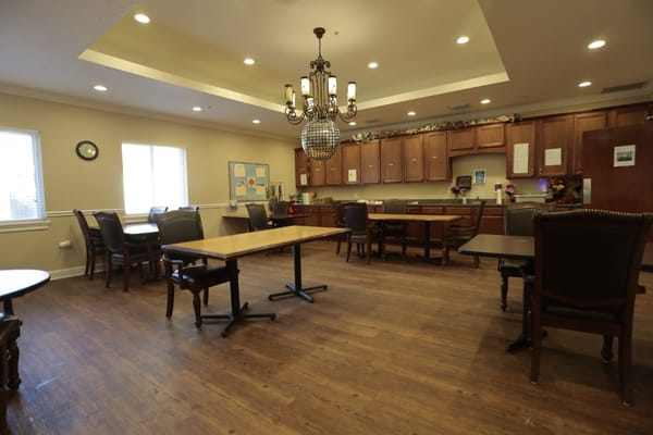 Bright common area with wooden tables and chairs
