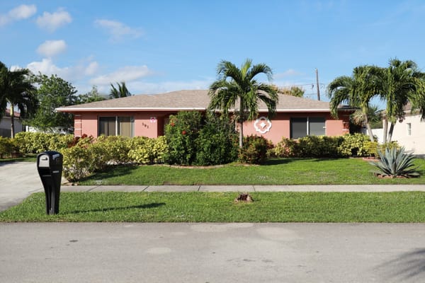 Exterior view of a residential facility surrounded by greenery