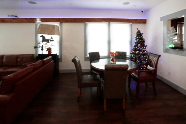 Common area with seating and a Christmas tree
