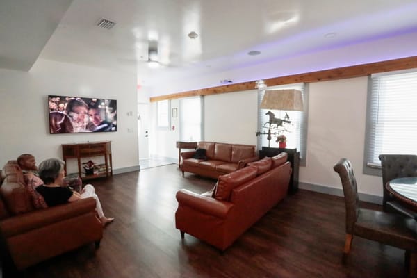 Residents socializing in a common area with seating