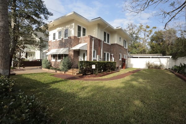 Exterior view of the facility with lawn and garden