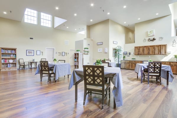 Bright dining area with wooden floors and tables