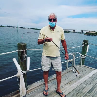 Senior man fishing by the waterfront