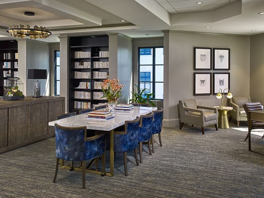 Cozy interior common area with seating and bookshelves